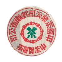 Big Green Mark sheng puerh cake in its paper wrapper