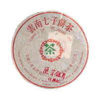 Gatekeeper sheng puerh cake in its paper wrapper