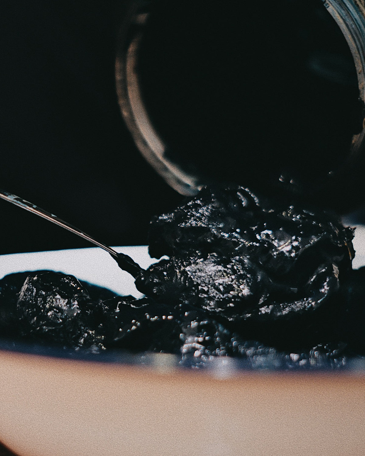 Lifting fermented indigo paste from the bowl