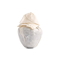 Reishi sheng puerh mushroom cake in its paper wrapper