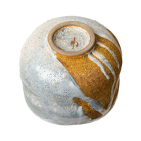 Underside of the Winter Dawn chawan, showing the unglazed foot ring and glaze running toward it.